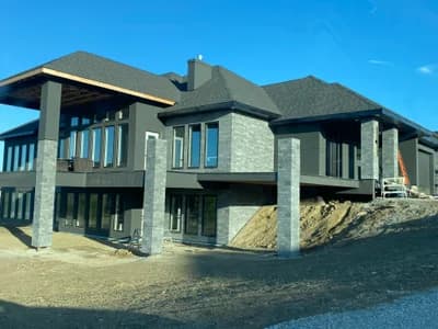Modern luxury home with stone pillars - side view