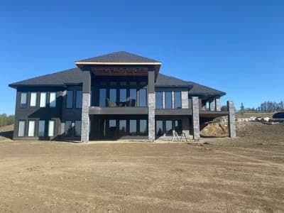 Modern luxury home with stone pillars - full view