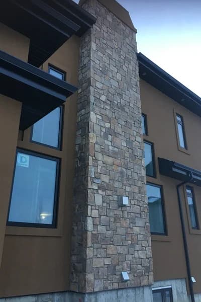 Professional stone chimney on modern residence